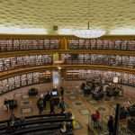A spacious interior view of Stockholm Public Library, showcasing its circular design and bookshelves.